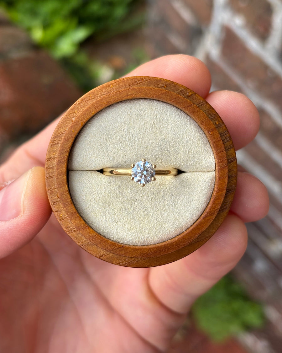 0.75ct round cut diamond solitaire ring with a six-claw setting in 18ct yellow gold inside a wooden box.