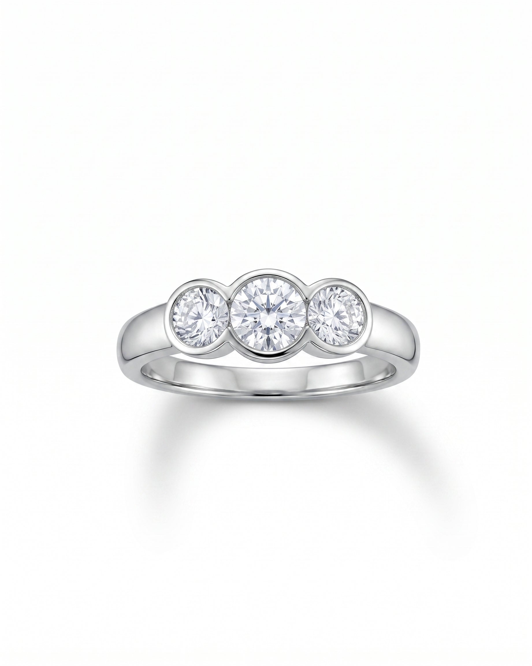Platinum trilogy ring with three round brilliant cut diamonds.