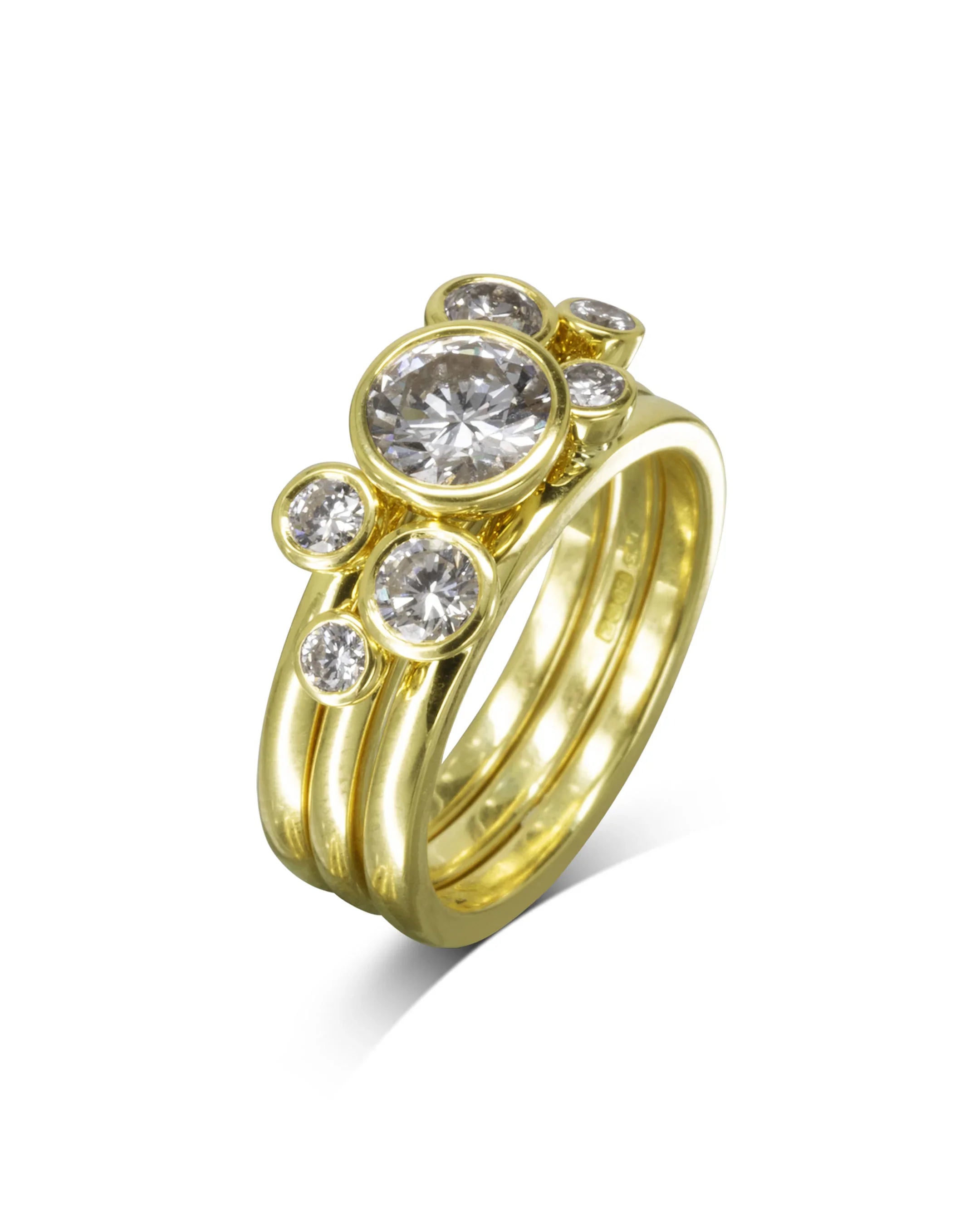 Gold stacking ring set with round diamonds in bezel settings, handmade luxury jewelry