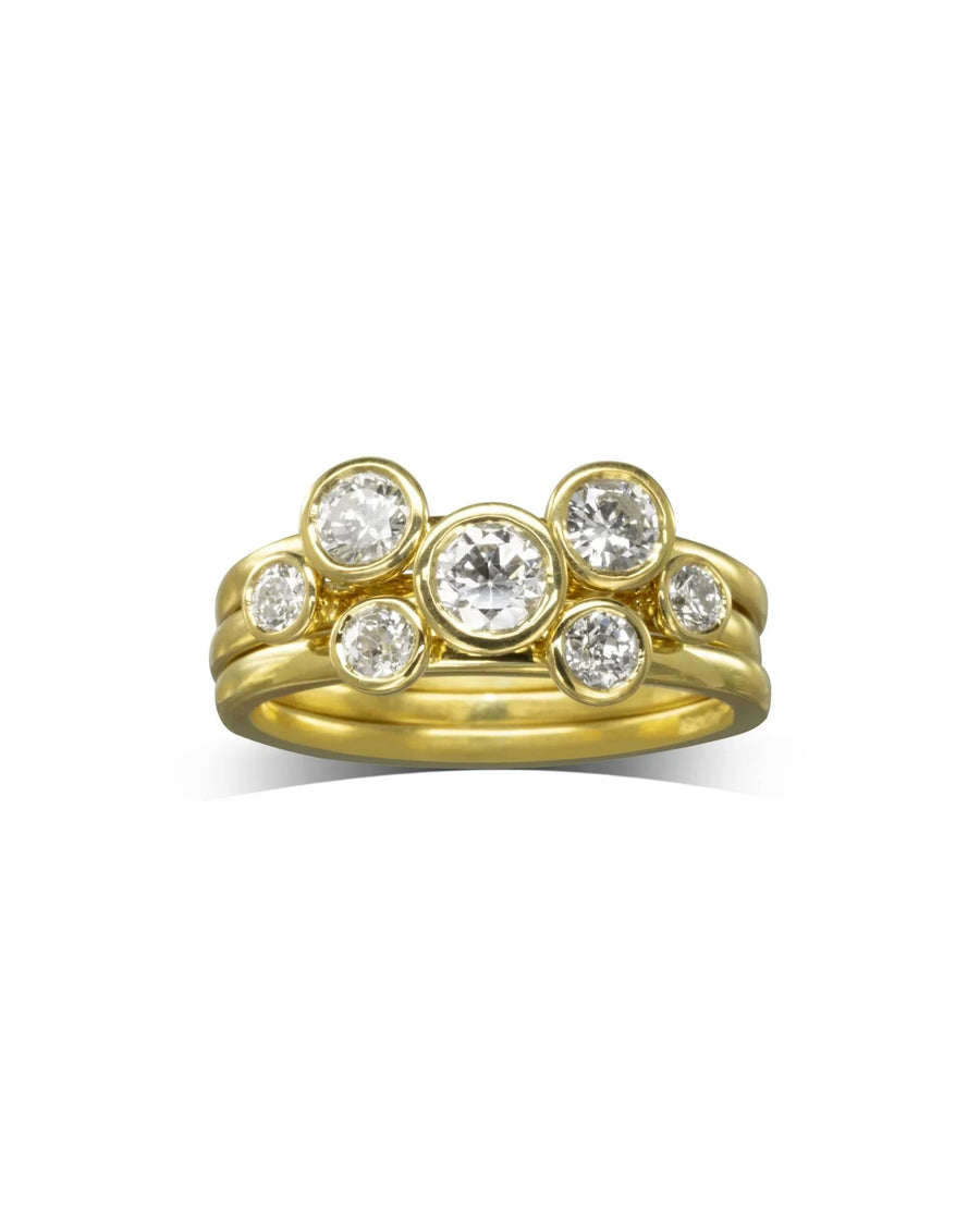Yellow gold stacking rings with round brilliant diamonds.