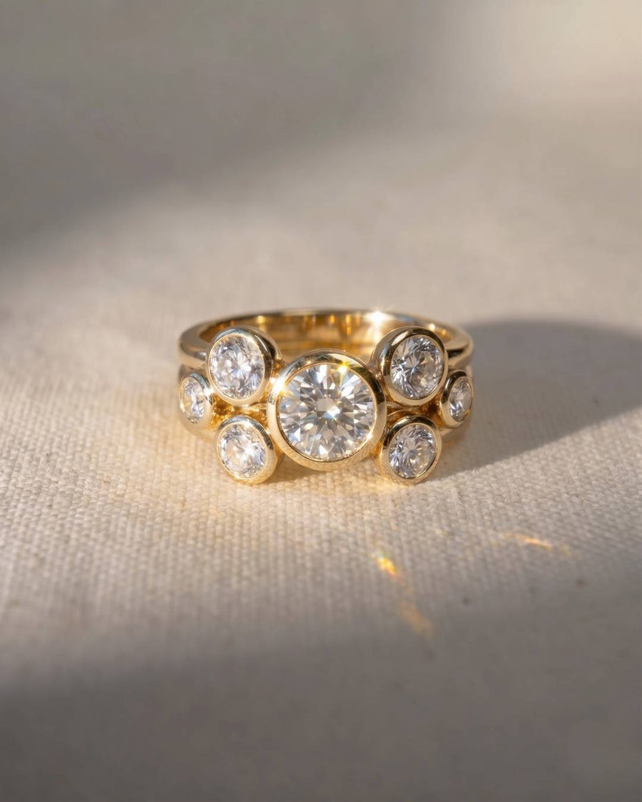 Yellow gold stacking rings with round brilliant diamonds in bezel settings.