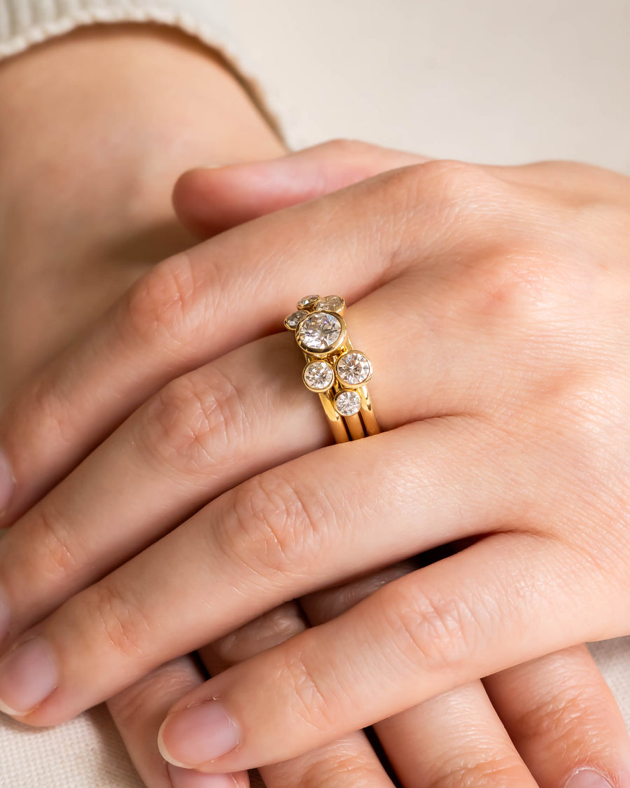 Yellow gold stacking rings with round brilliant diamonds.