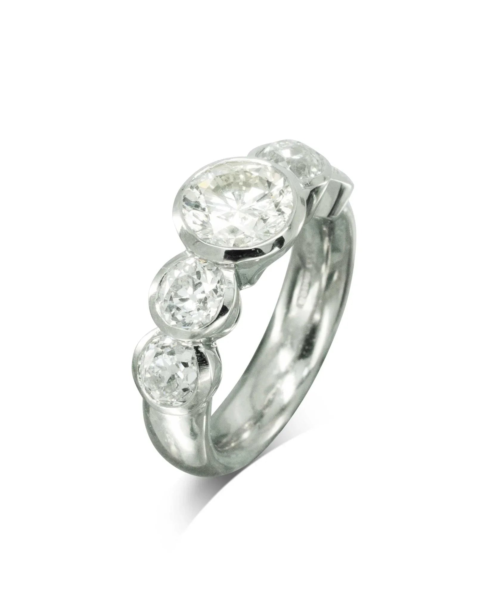 Platinum engagement ring with five round brilliant diamonds in a contemporary handmade setting