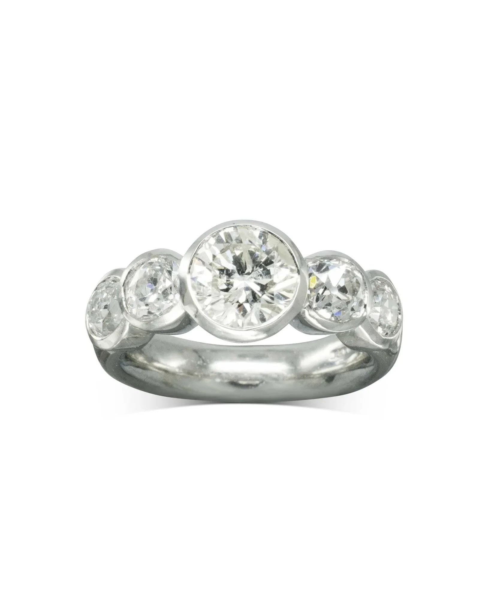 Platinum engagement ring with five round brilliant diamonds in a modern bezel setting