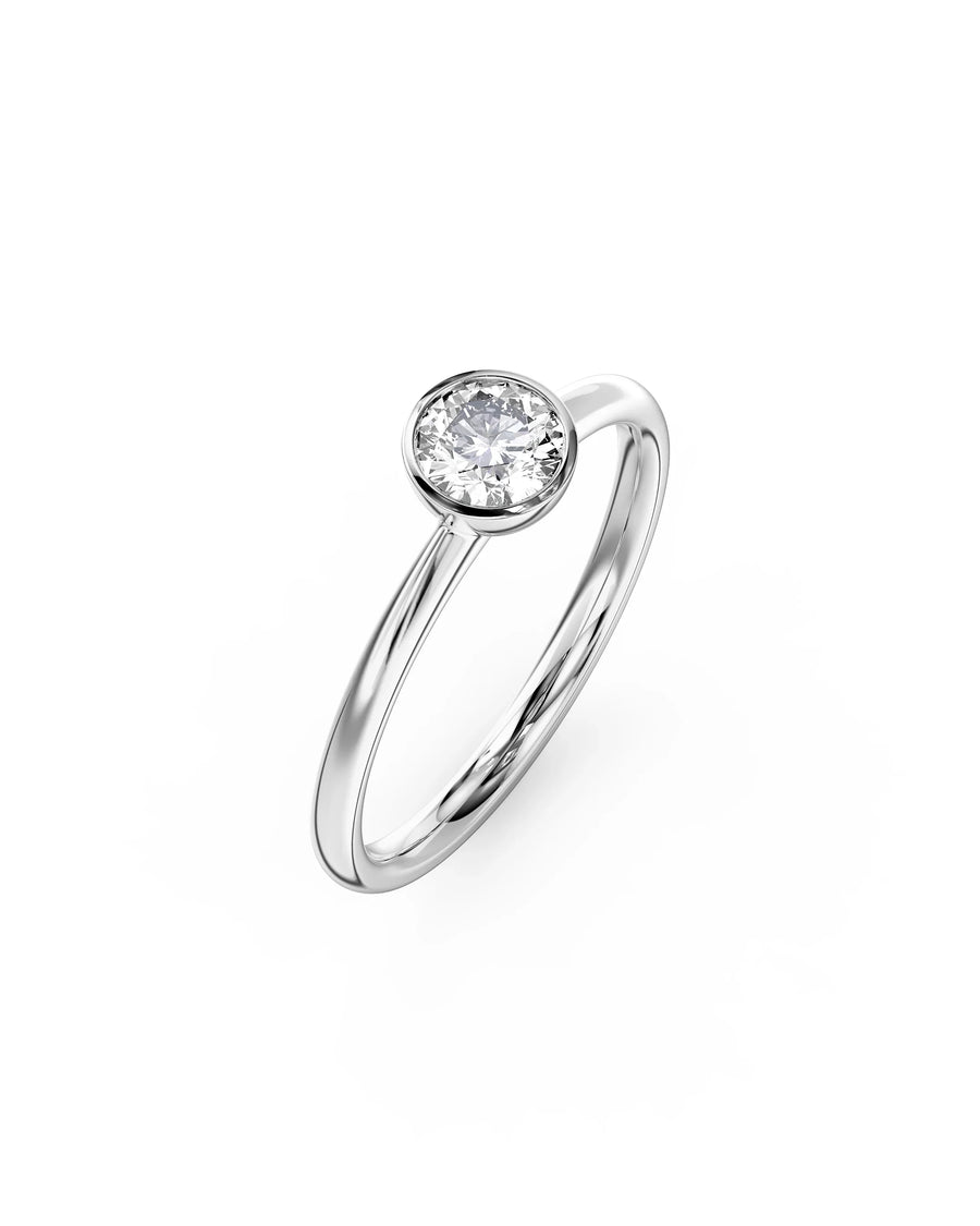 Silver round cut bezel engagement ring with a single diamond.