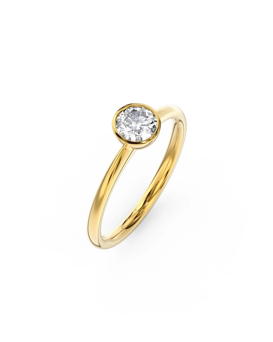 Yellow gold engagement ring with a round cut natural diamond in a bezel setting.