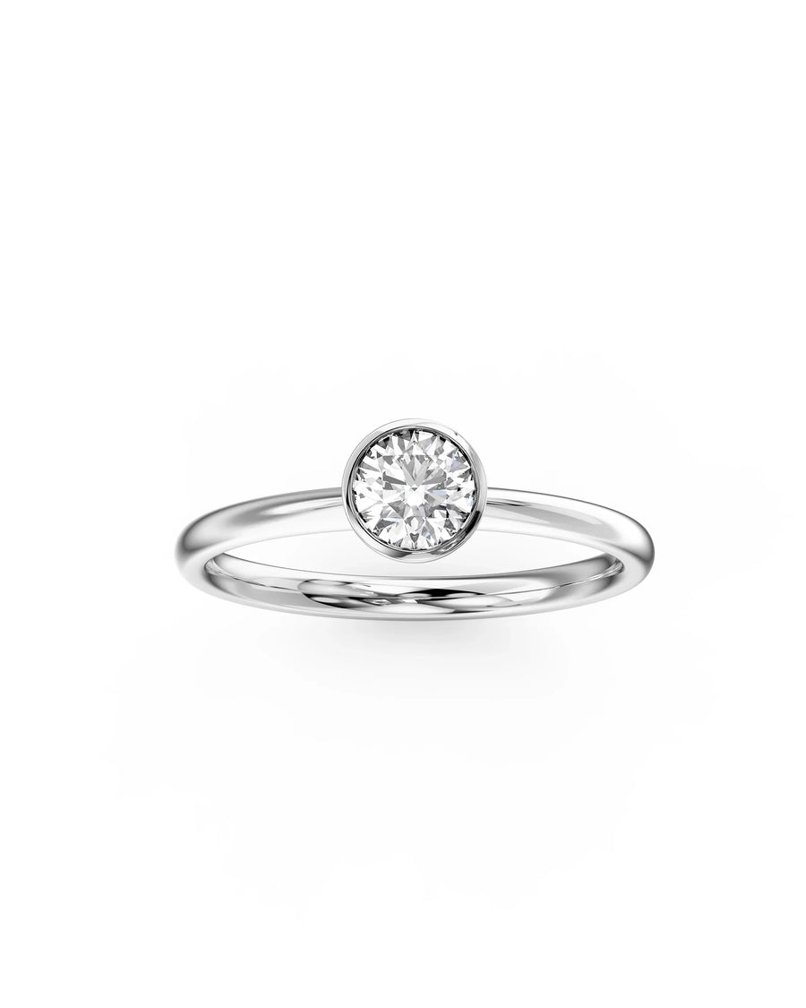 Silver round cut bezel engagement ring with a single diamond.