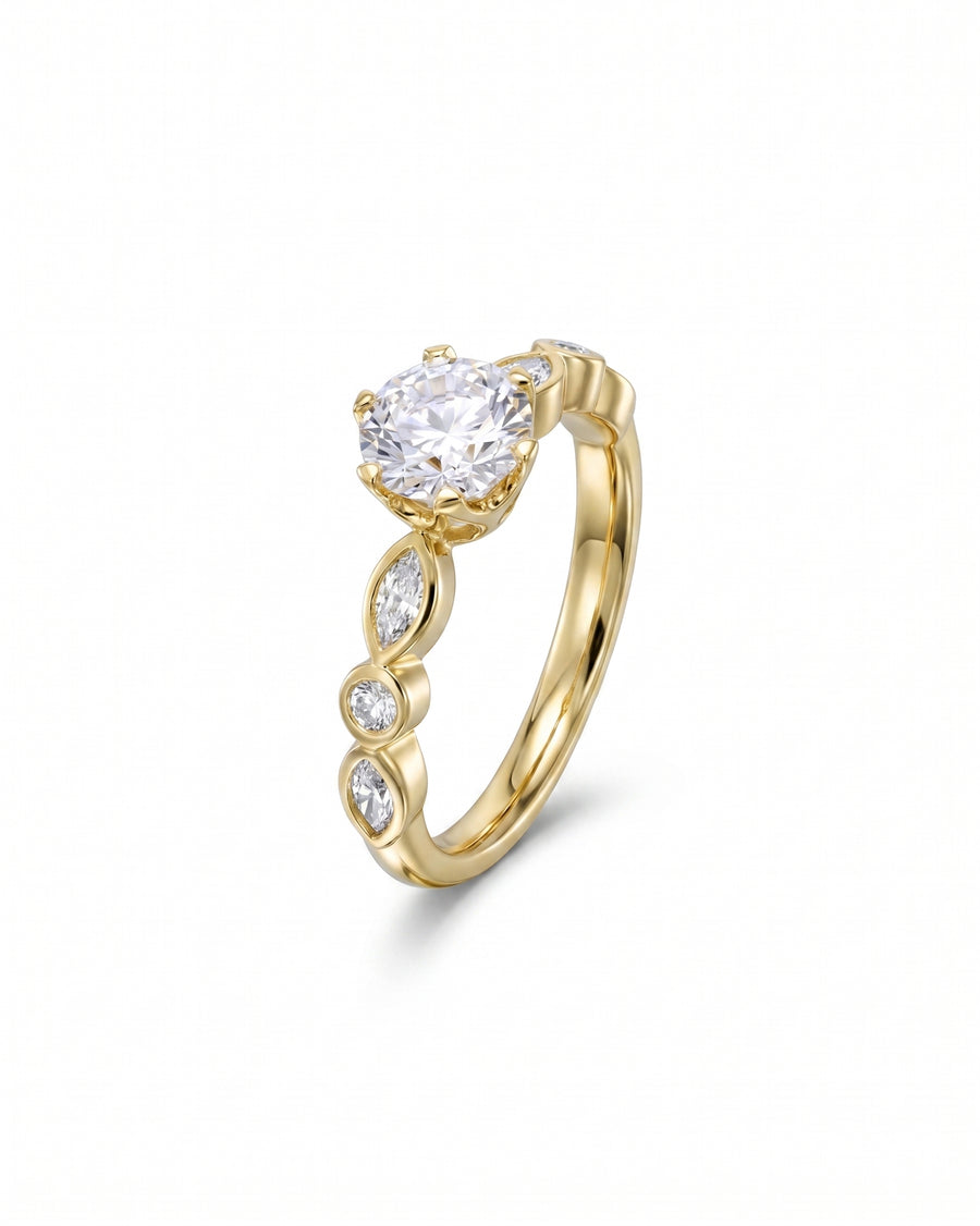 Yellow gold engagement ring with a round cut diamond and marquise side stones.