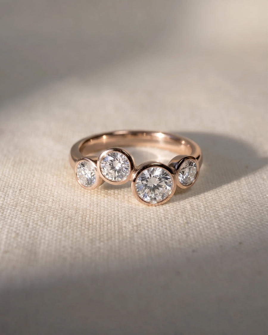 18ct rose gold engagement ring with four round lab grown diamonds in a bubble design.