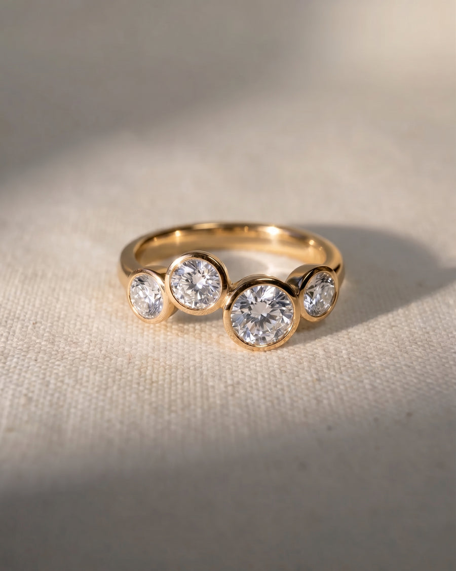 18ct yellow gold engagement ring with four round lab grown diamonds in a bubble design.