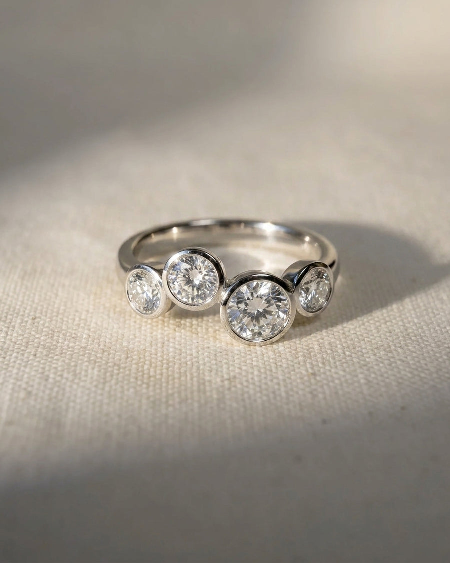 Platinum engagement ring with four round cut lab grown diamonds in a bubble design.