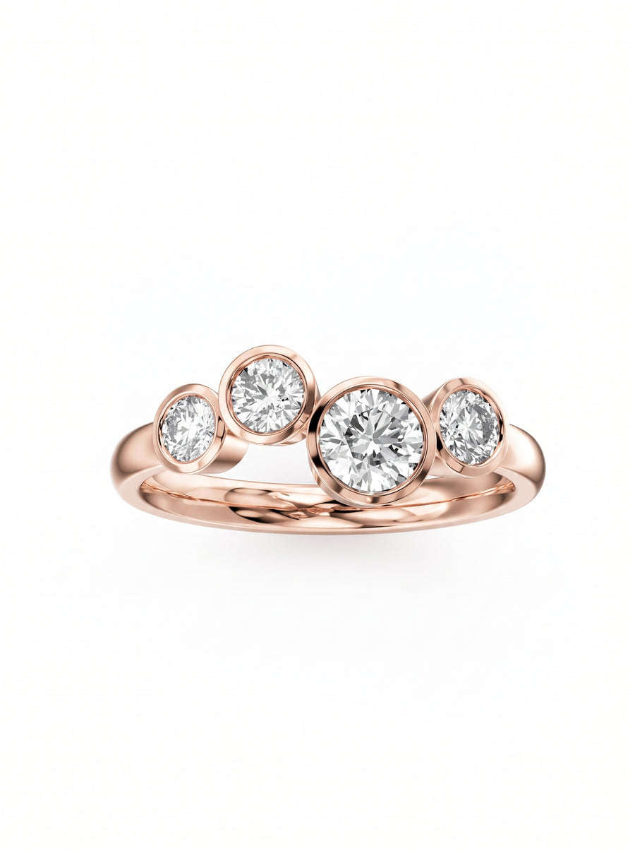 Rose gold engagement ring featuring four bezel-set round cut diamonds in a staggered bubble design.