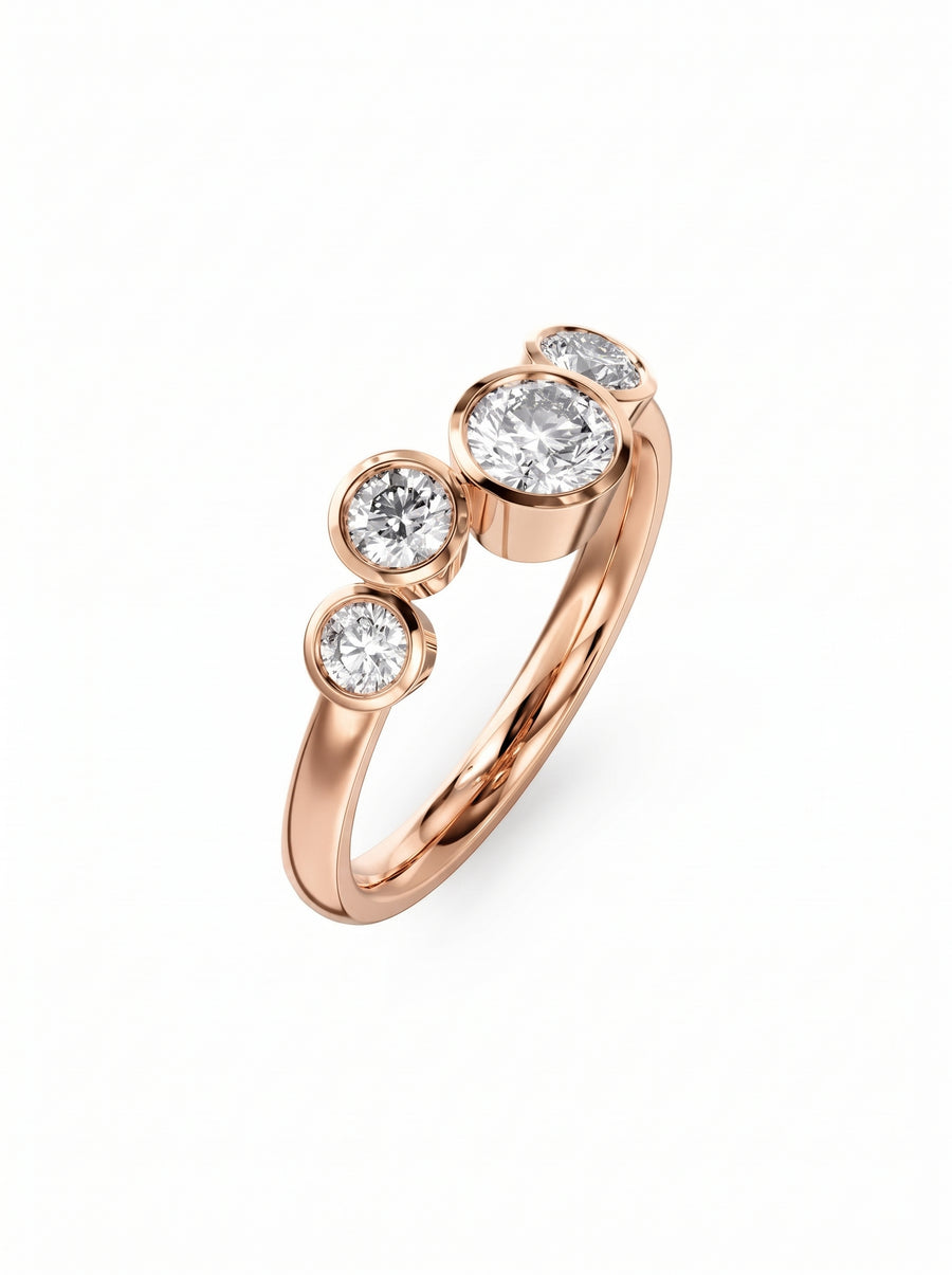 Rose gold engagement ring featuring four bezel-set round cut diamonds in a bubble-style design.
