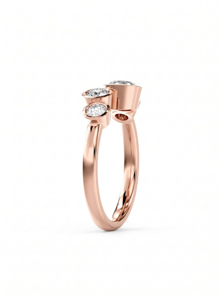 Rose gold engagement ring featuring four bezel-set round cut diamonds in a bubble-inspired design.