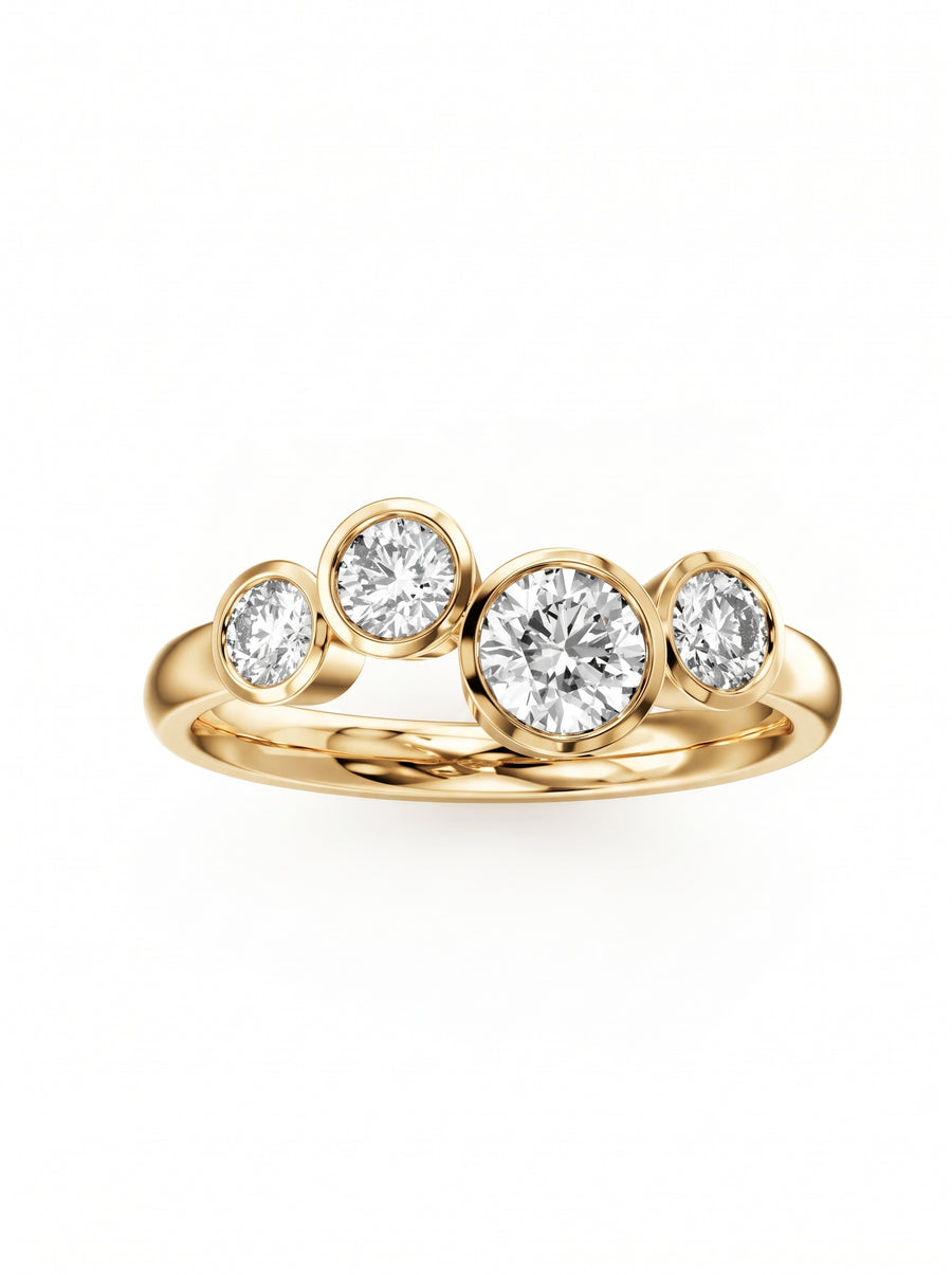Gold engagement ring featuring four bezel-set round diamonds in a staggered bubble design.
