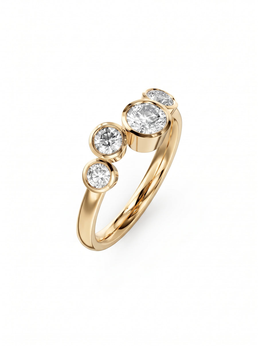 Gold engagement ring with four bezel-set round diamonds in a graduated bubble design.