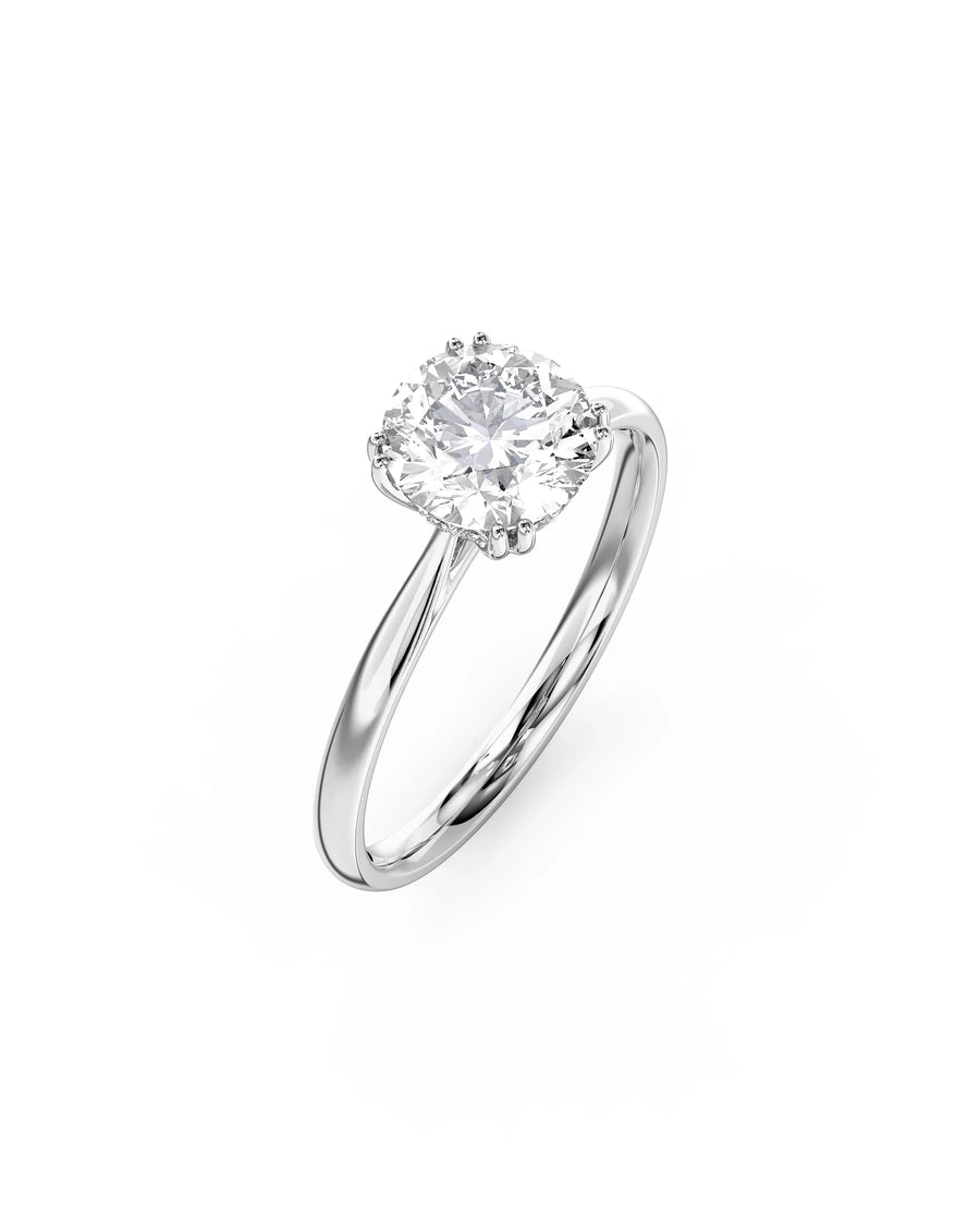 Silver engagement ring with a round cut diamond and hidden halo.