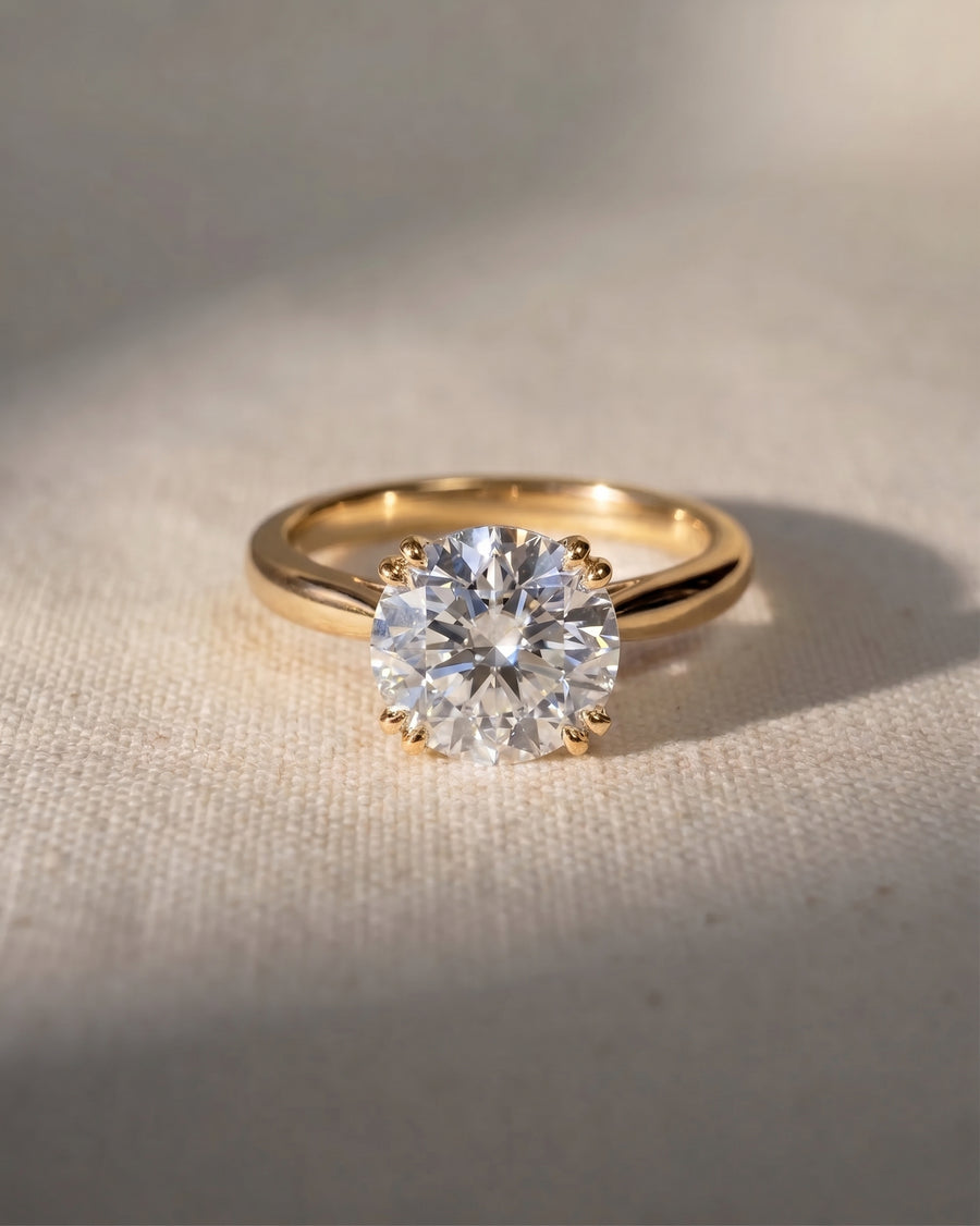 18ct yellow gold engagement ring with a round cut lab grown diamond.