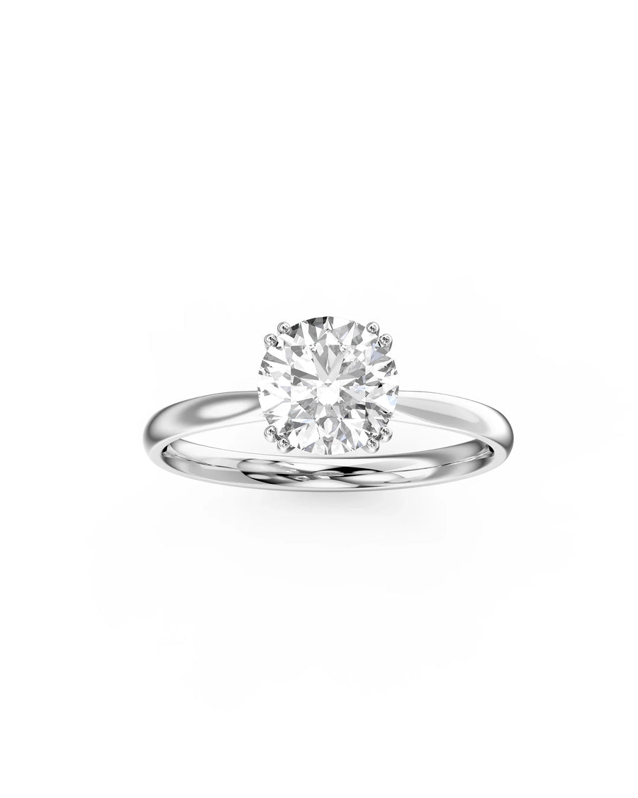 Platinum round cut hidden halo engagement ring with a large center diamond.