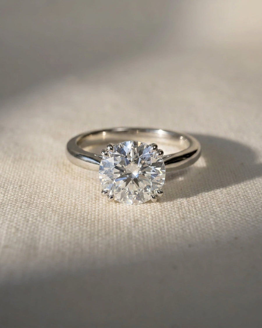 Platinum round cut hidden halo engagement ring with a 1ct lab grown diamond.