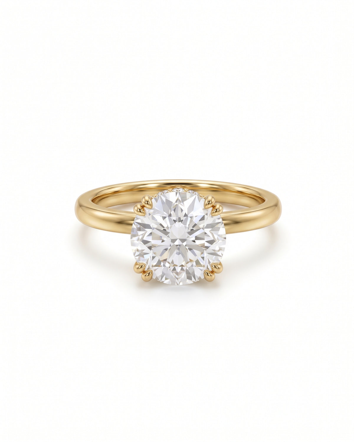 Round cut diamond engagement ring with a hidden halo on a polished yellow gold band.