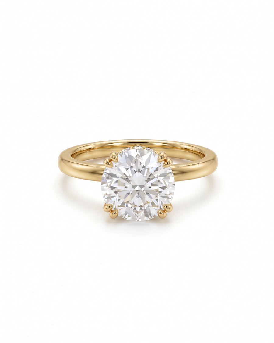 Round cut diamond engagement ring with a hidden halo on a polished yellow gold band.