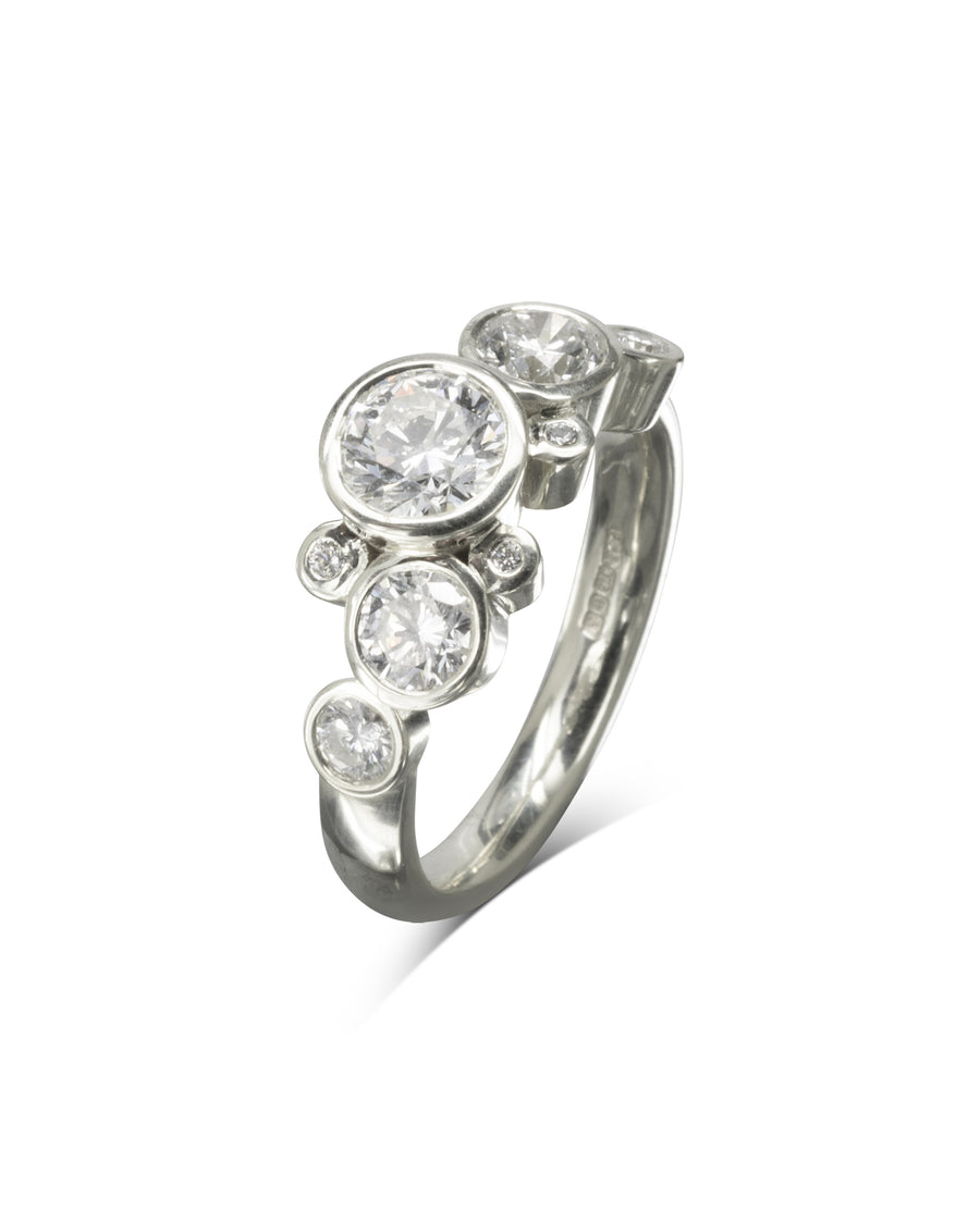 Silver ring with round cut diamonds in a water bubbles design.
