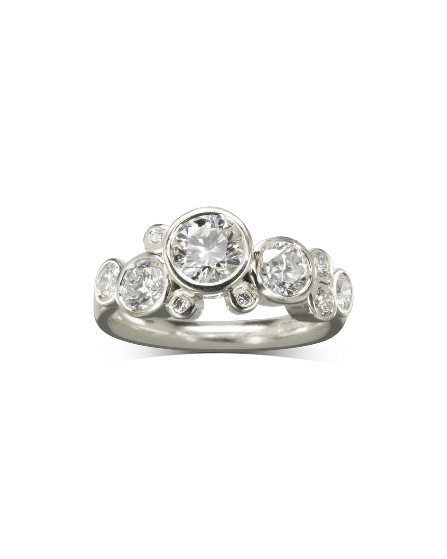 Silver engagement ring with round cut diamonds in a bubble design.