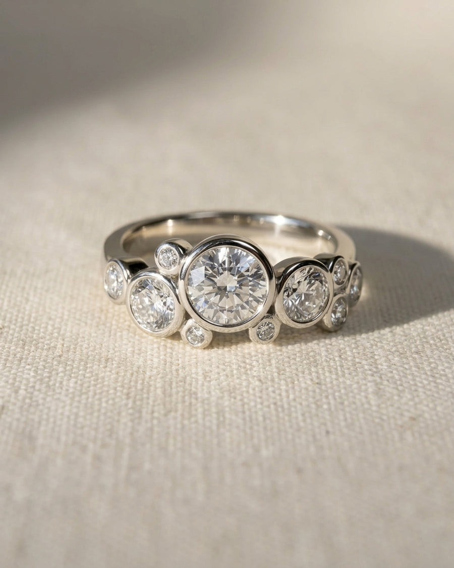 Platinum ring with round cut lab grown diamonds in a water bubbles design.