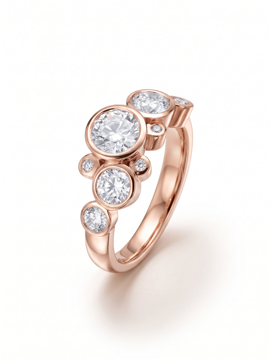 Rose gold engagement ring featuring bezel-set round cut diamonds in a cluster bubble design.