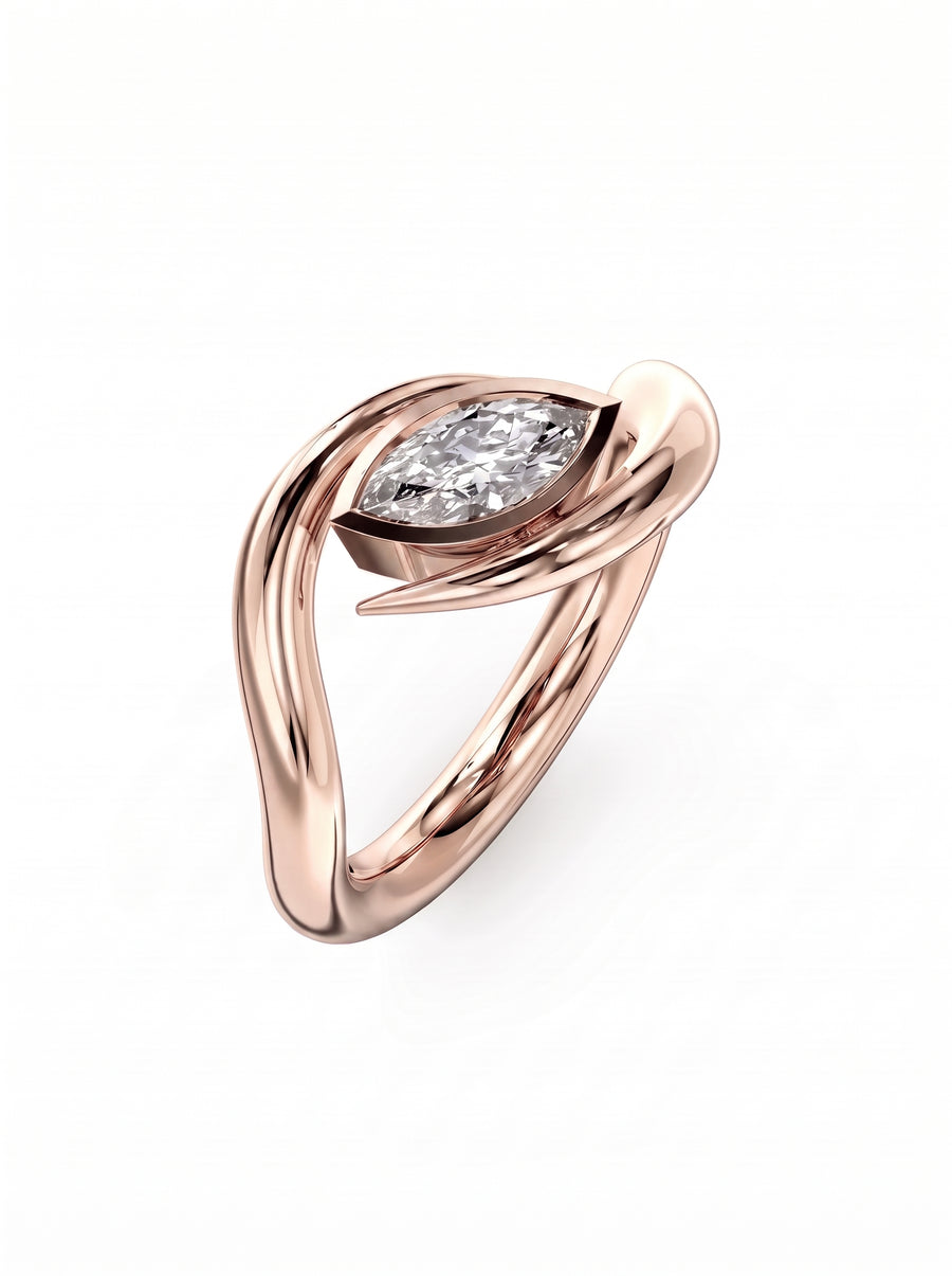 Rose gold engagement ring featuring a marquise cut diamond in a unique, spiky wraparound band design.