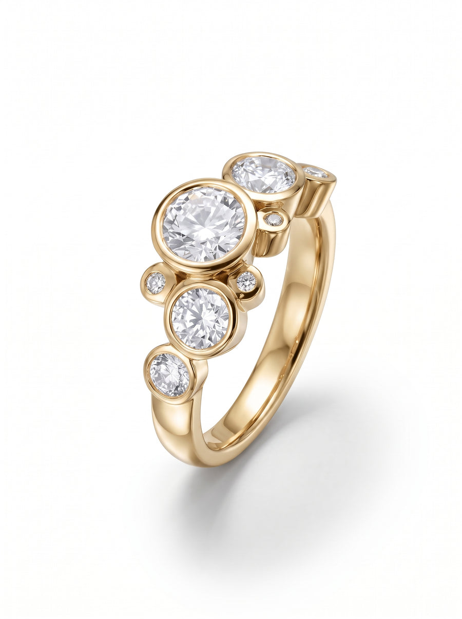 Gold engagement ring featuring multiple round cut diamonds in a bubble-style bezel setting.