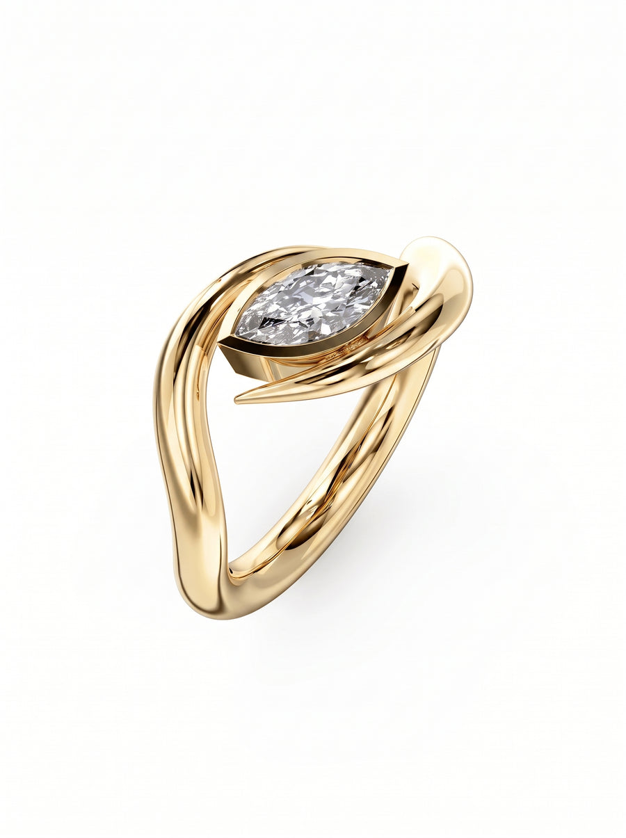 Gold engagement ring featuring a marquise cut diamond set in a curved, spiky metal band.