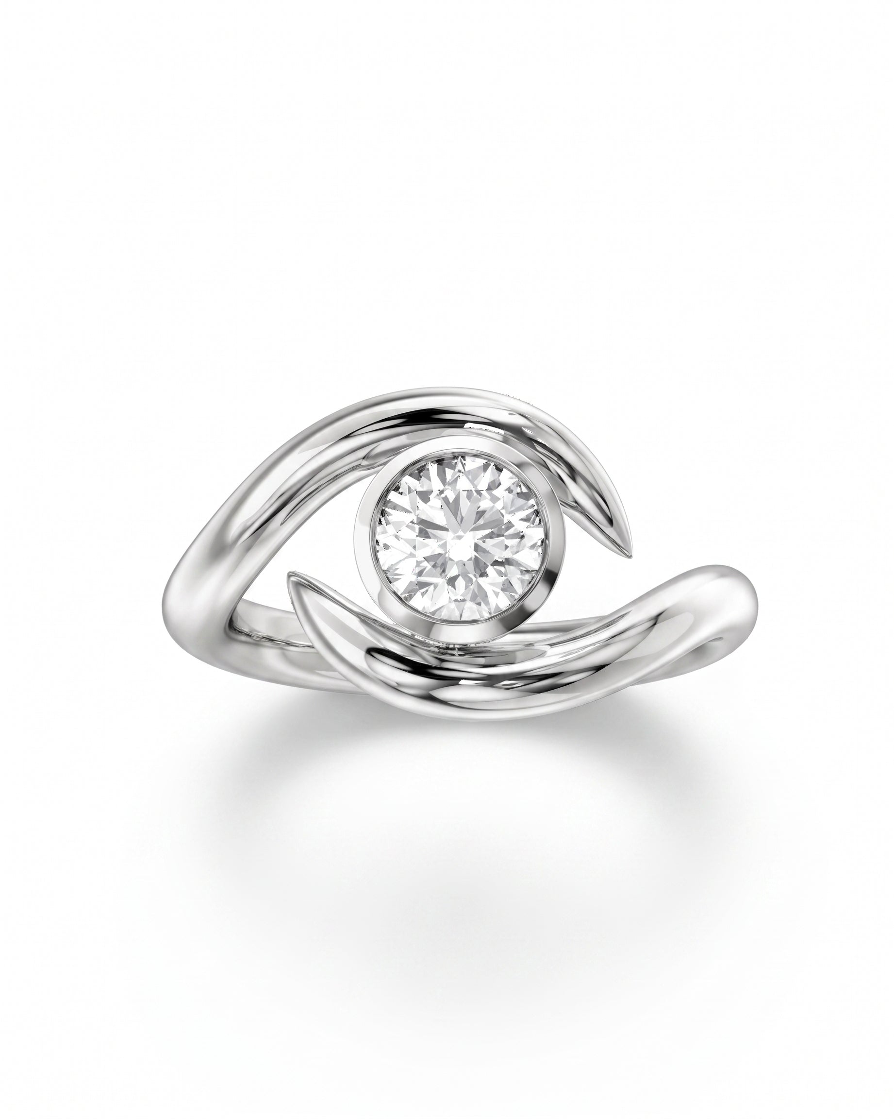 Silver round cut spiky engagement ring with a bezel-set diamond.