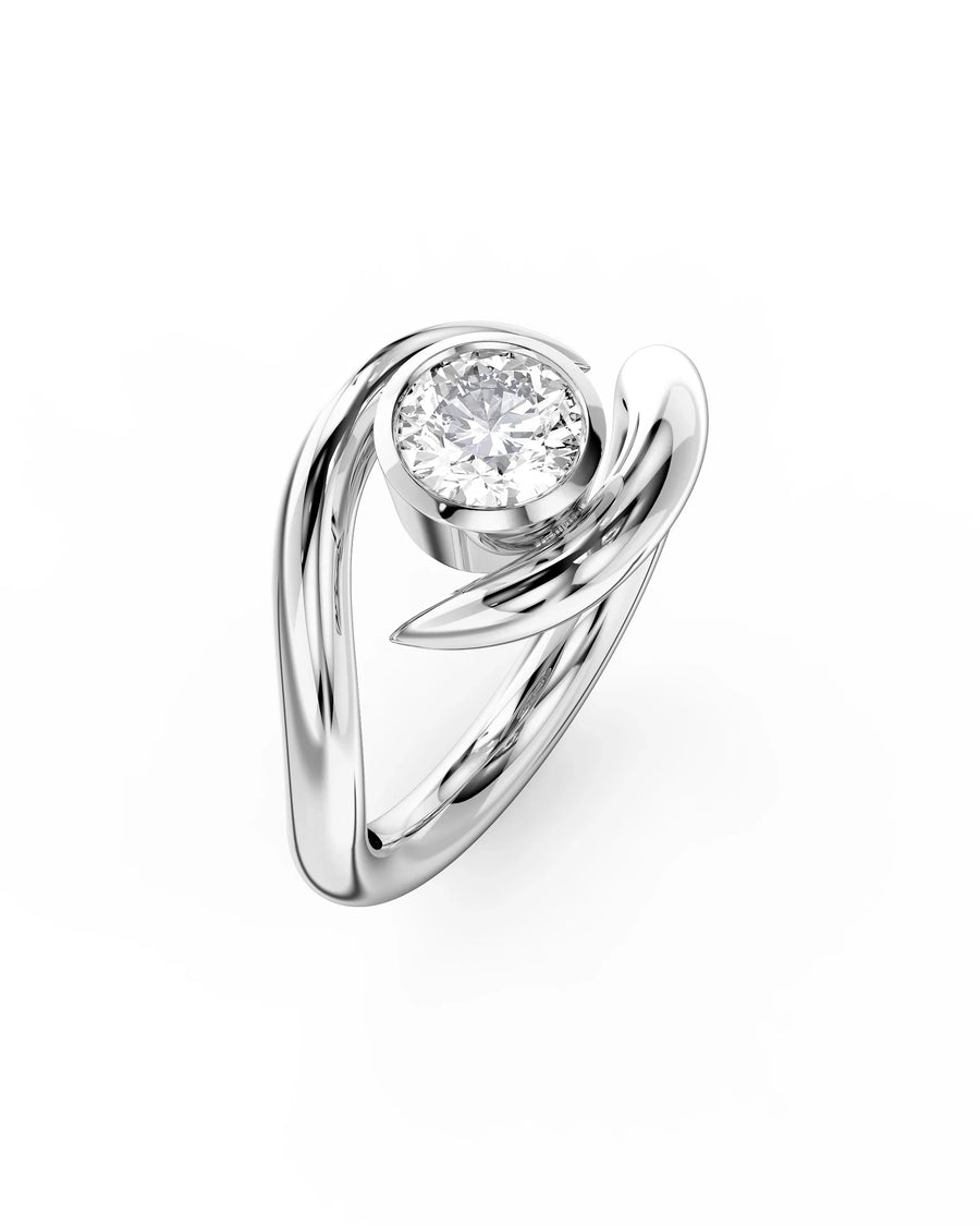 Silver engagement ring with a round cut diamond in a bezel setting and a spiky, twisted band.