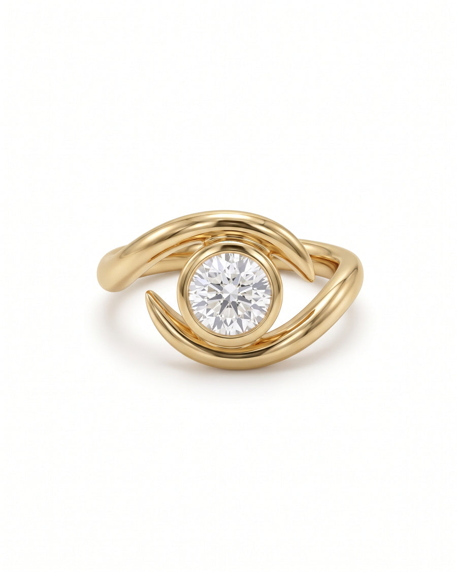 Round cut diamond engagement ring in a gold bezel setting with a spiky, wrap-around band design.