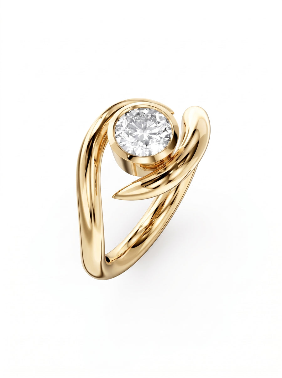 Round cut diamond engagement ring in polished yellow gold with a unique spiky, asymmetrical wrap design.