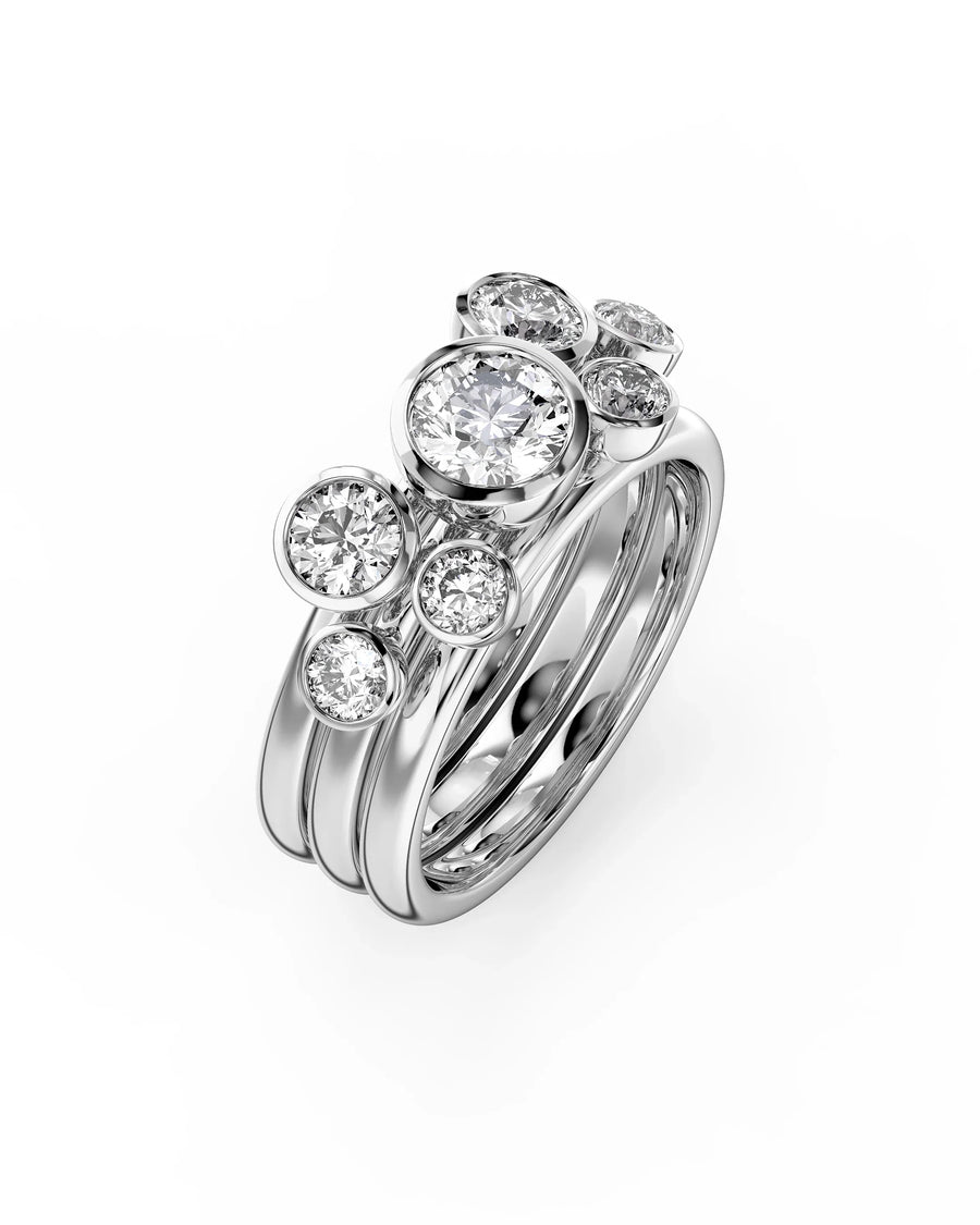 Silver stacking rings with multiple round cut diamonds.
