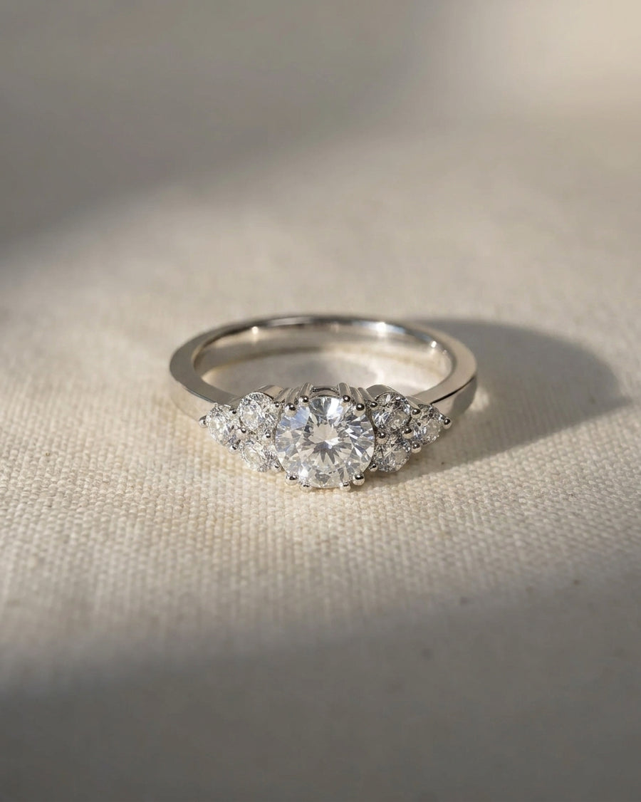 Platinum engagement ring with a round lab grown diamond and trefoil claw setting.