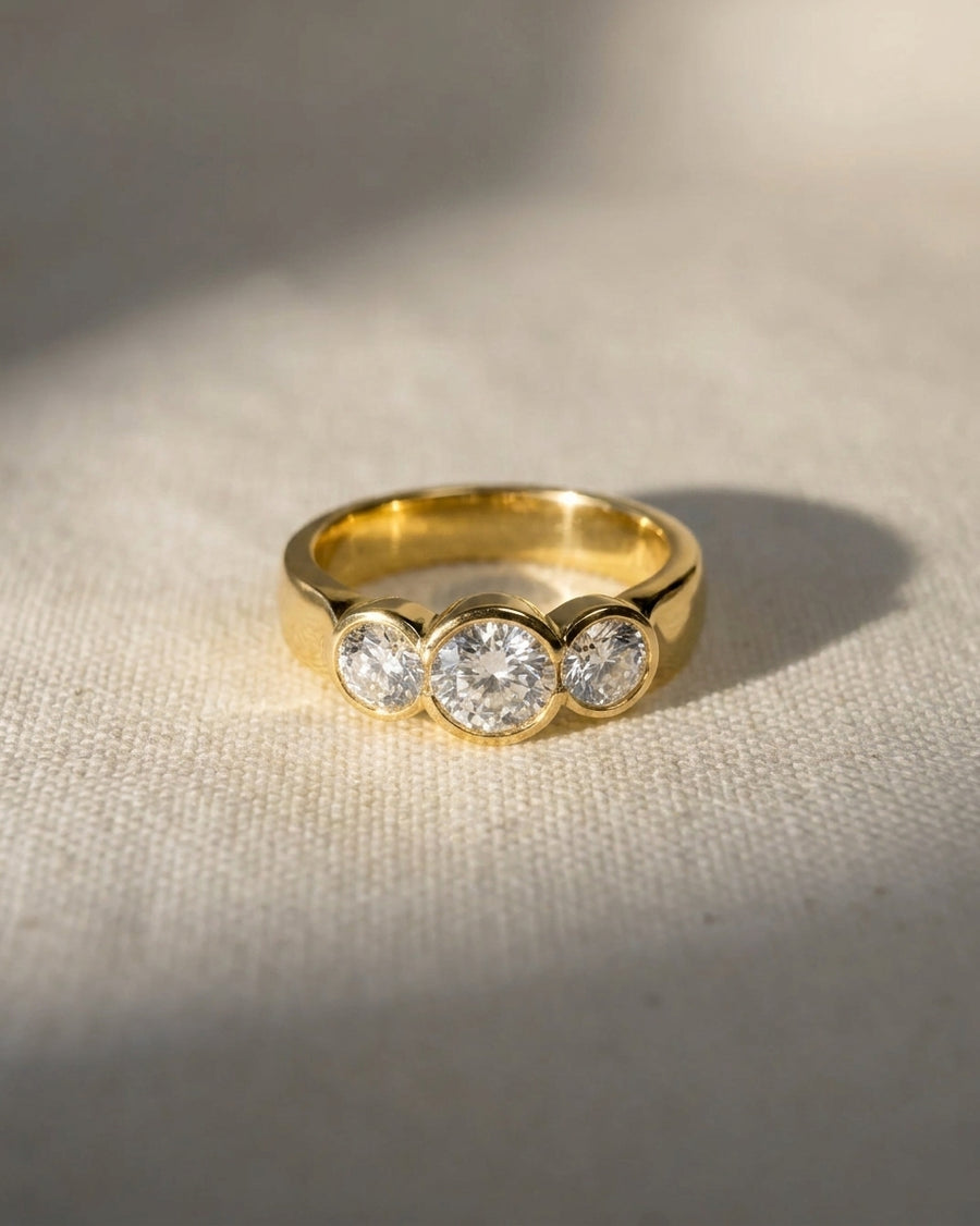 18ct yellow gold trilogy engagement ring with three round cut lab-grown diamonds.