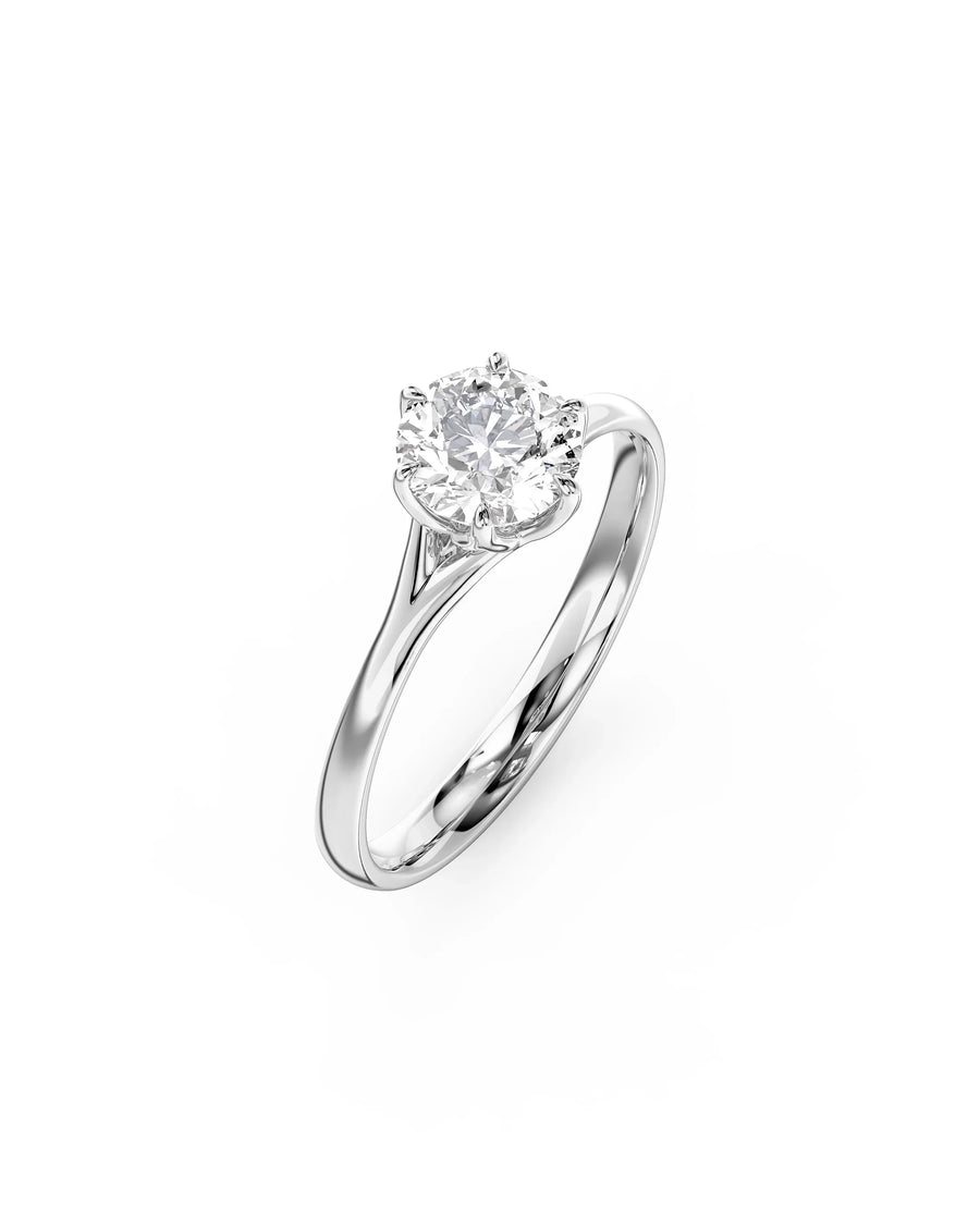 White gold engagement ring with a round cut diamond in a tulip claw setting.