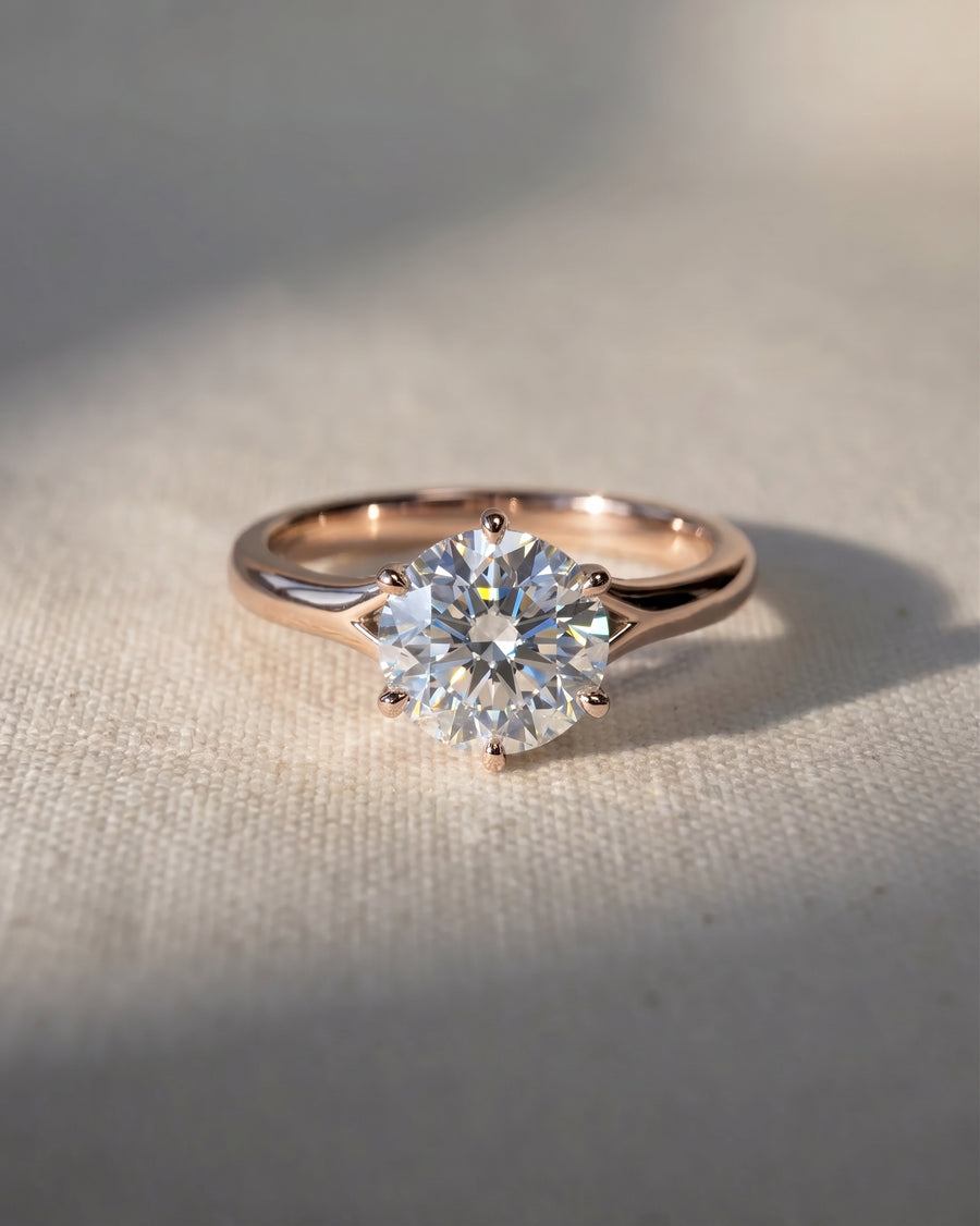 18ct rose gold engagement ring with a round cut lab-grown diamond in a tulip claw setting.