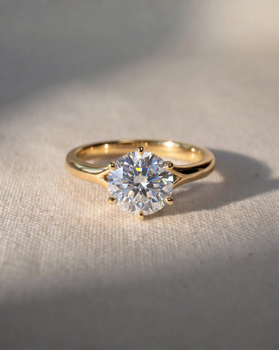 18ct yellow gold engagement ring with a round cut lab-grown diamond in a tulip claw setting.