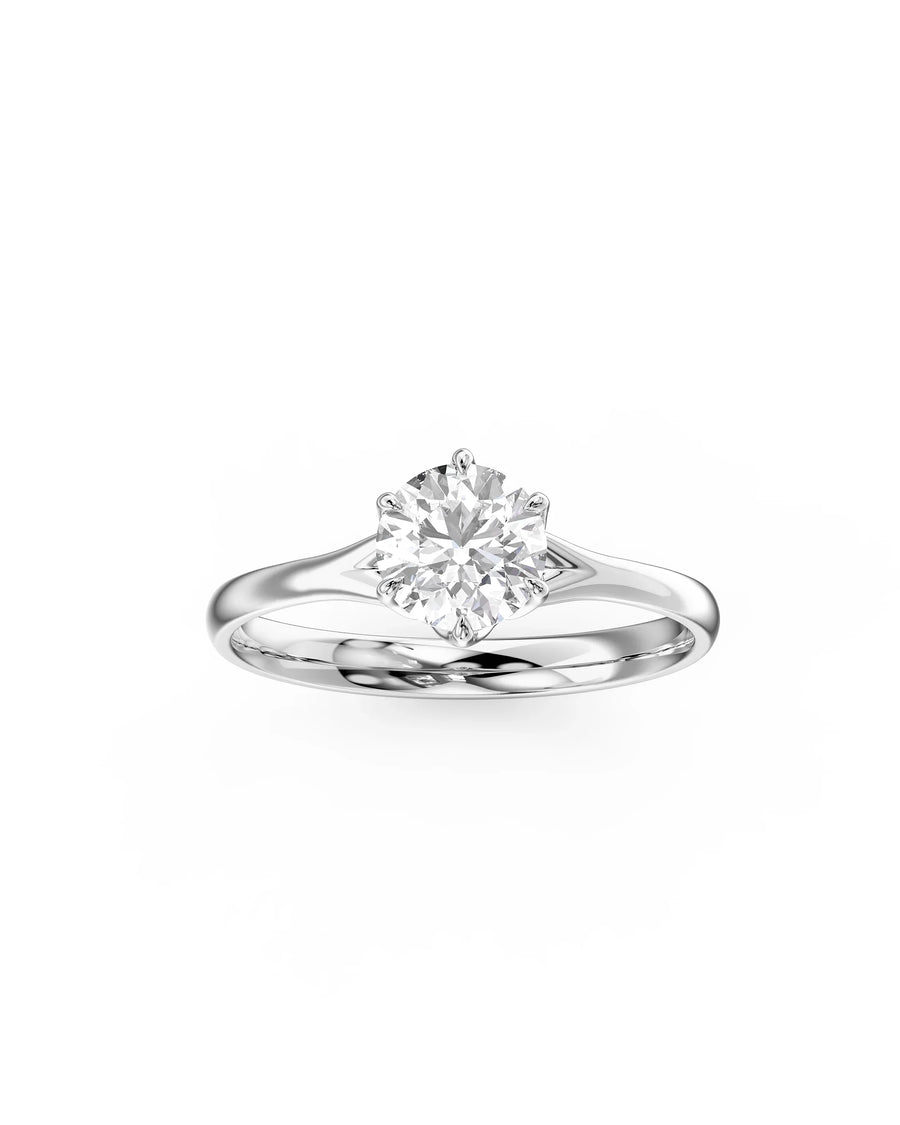 Silver round cut diamond engagement ring with tulip claw setting.