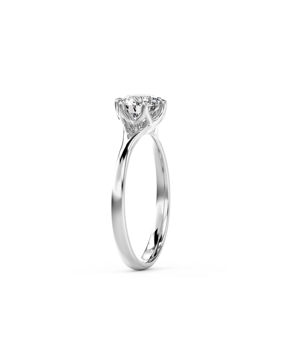 Silver round cut tulip claw engagement ring with a clear gemstone.