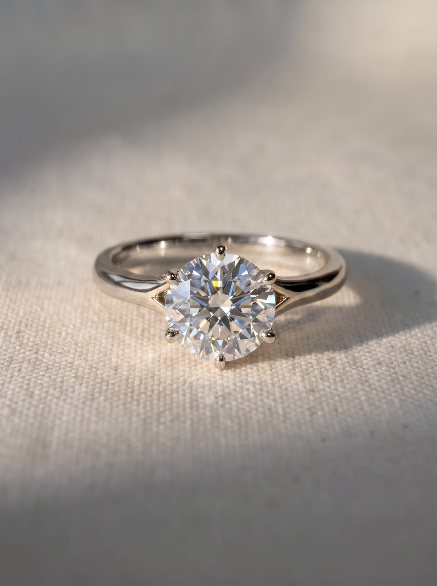 Round cut diamond engagement ring with a six-prong tulip setting on a polished white gold band.