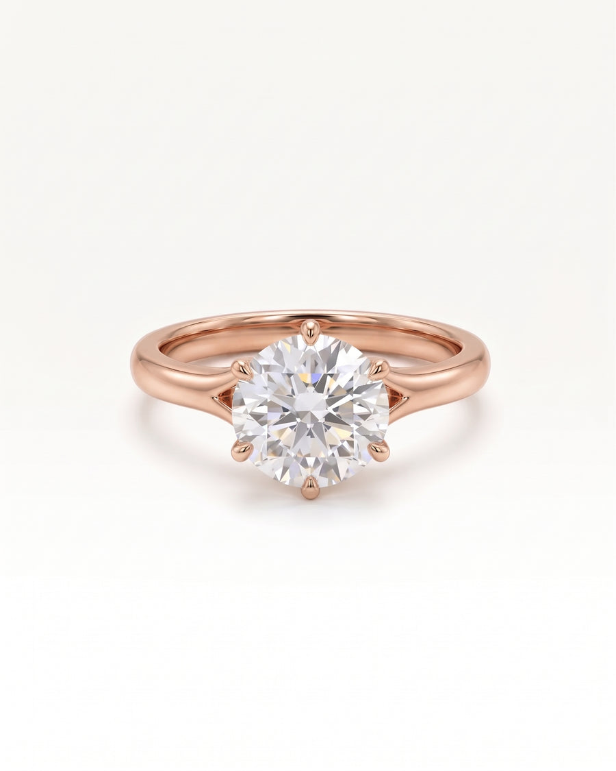 Round cut diamond engagement ring in 18ct rose gold with a six-prong tulip claw setting.