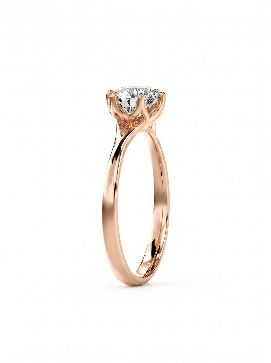 Round cut diamond engagement ring in rose gold with a tulip-style claw setting.