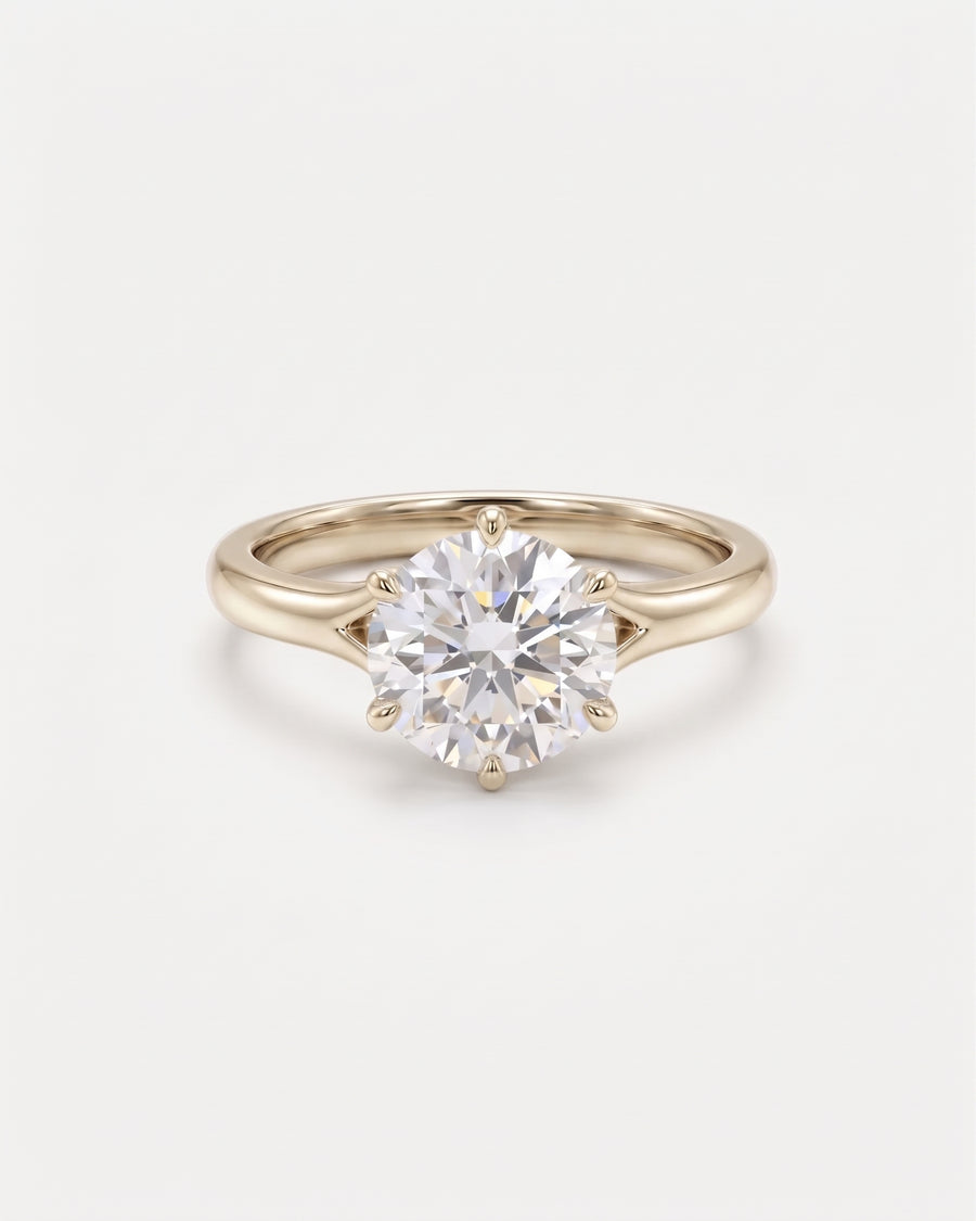 Round cut diamond engagement ring in 9ct yellow gold with a six-prong tulip claw setting.