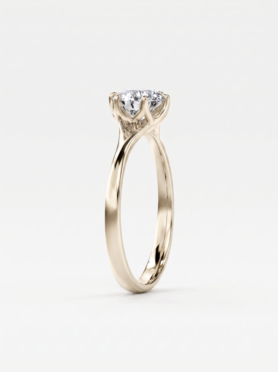Round cut diamond engagement ring in yellow gold with a tulip-shaped claw setting.